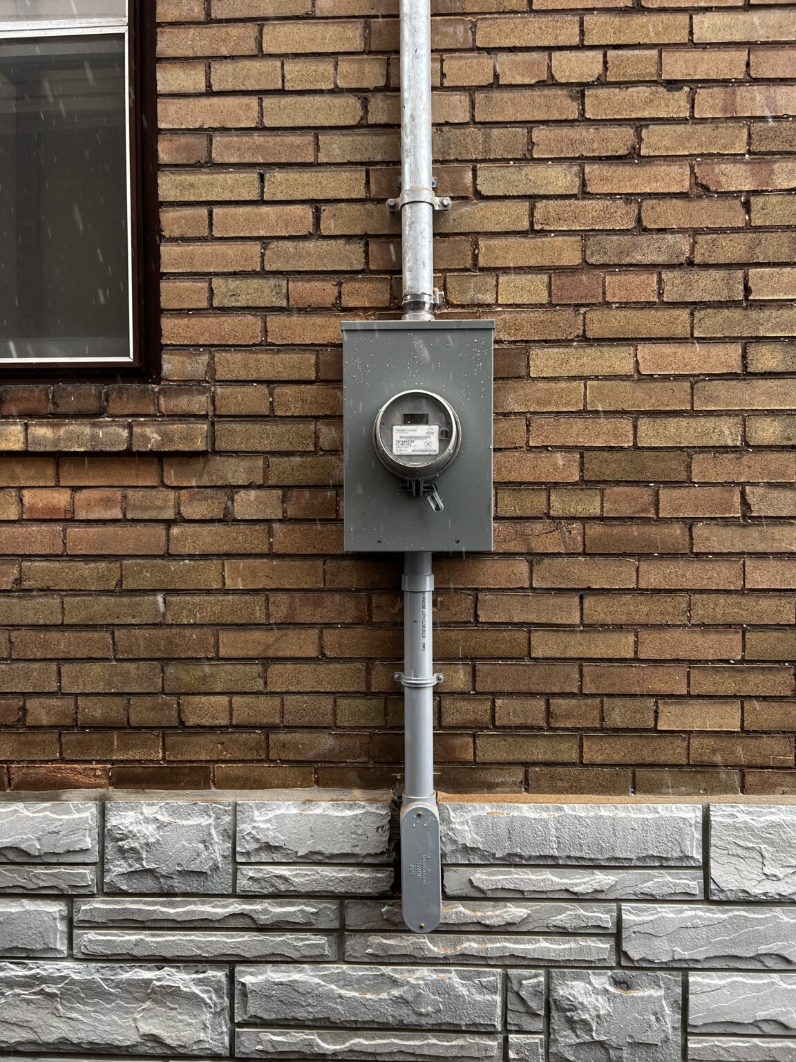 Completed exterior electrical service and meter installation on a Toronto brick home