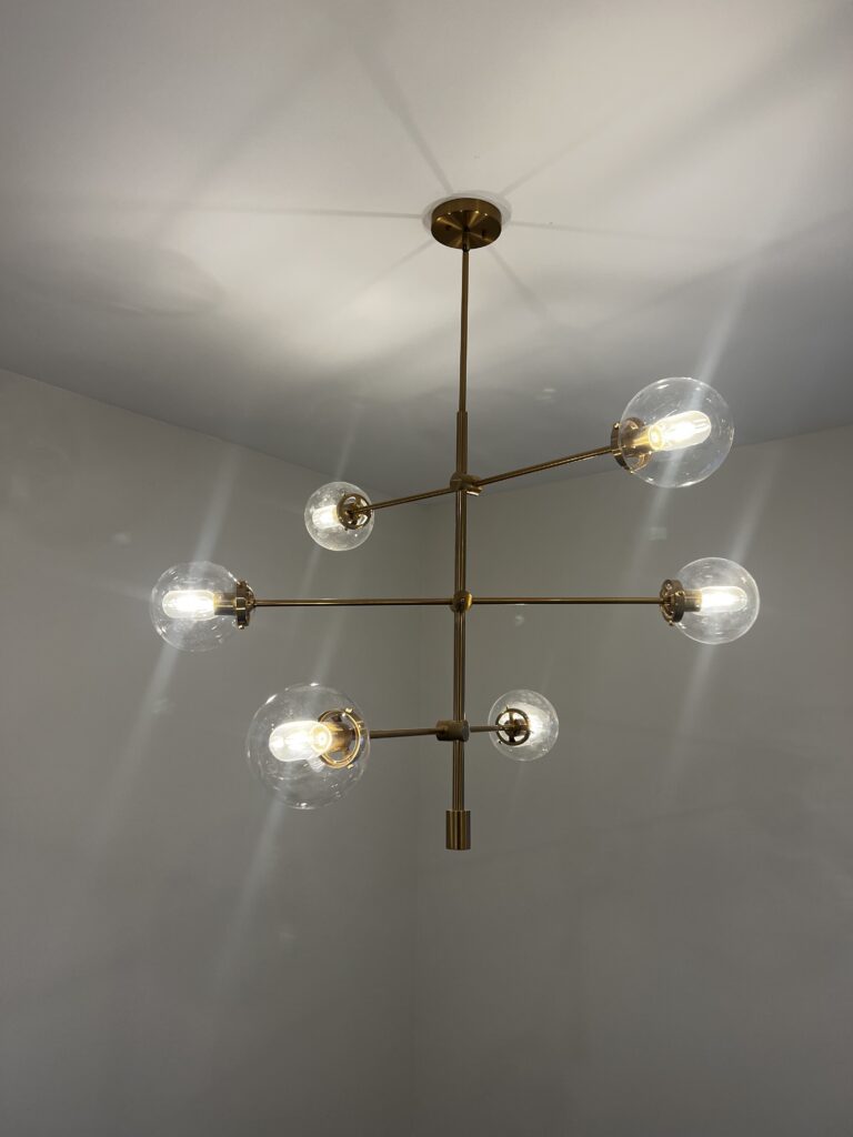 Modern brass chandelier with six glass-globe lights