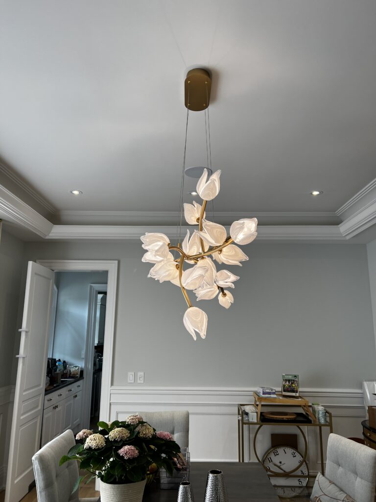 Leaf-shaped chandelier above a dining area