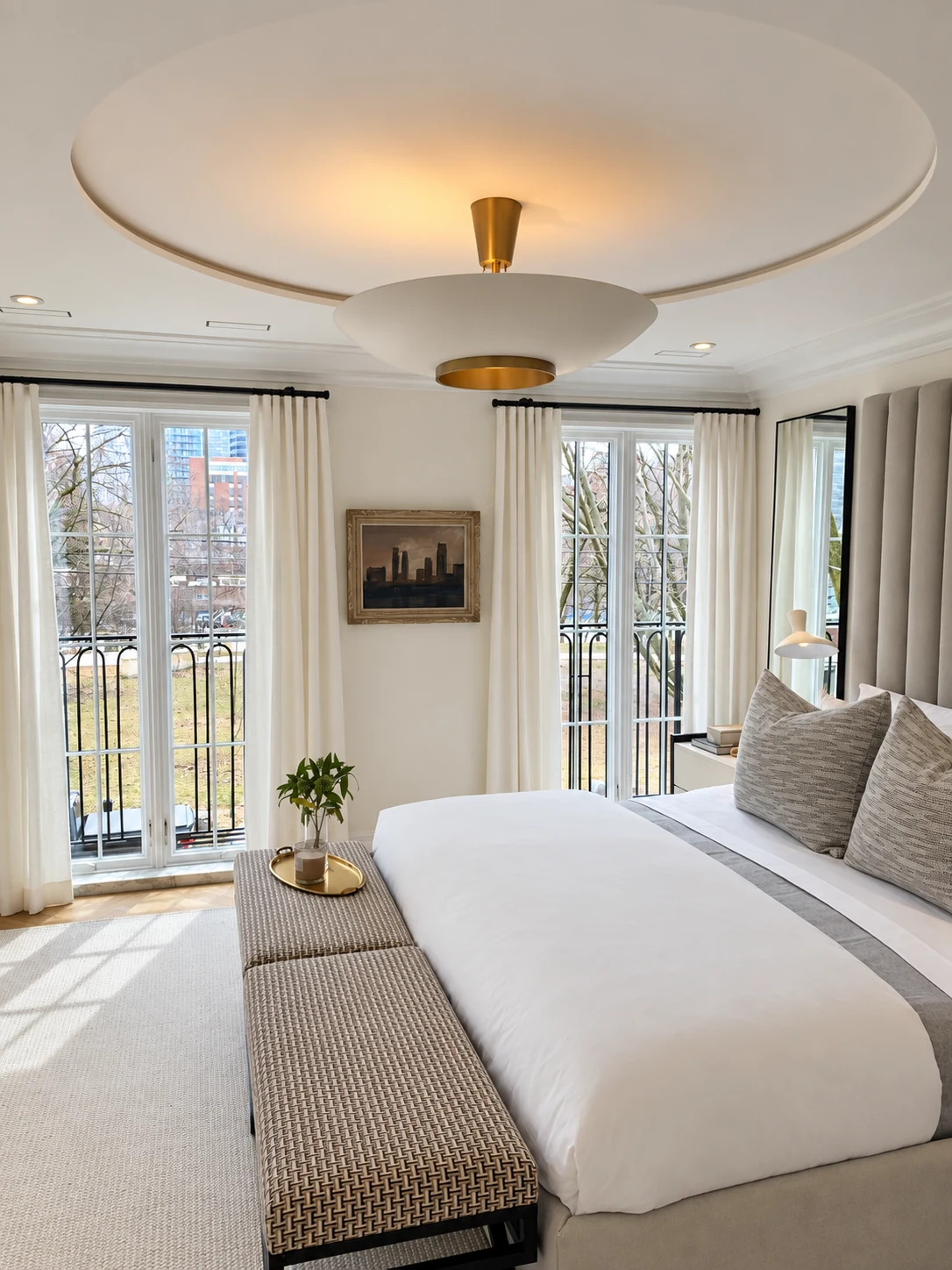 White and brass bowl pendant beneath a circular bedroom ceiling recess