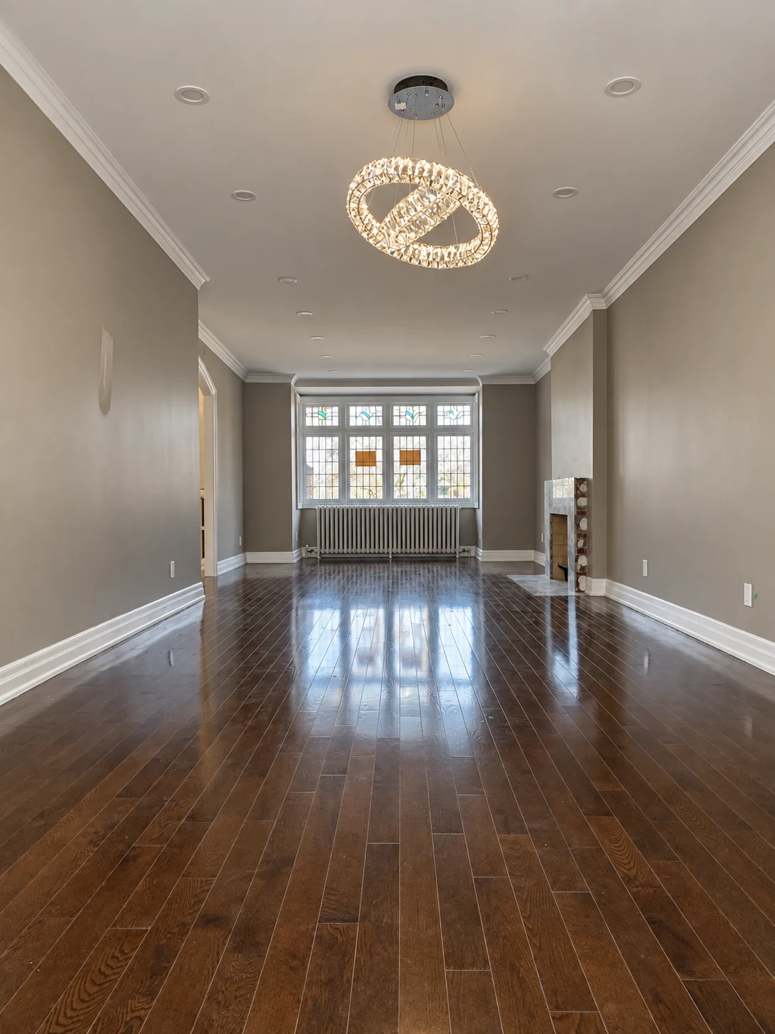 Illuminated intertwined crystal ring chandelier in a renovated living room