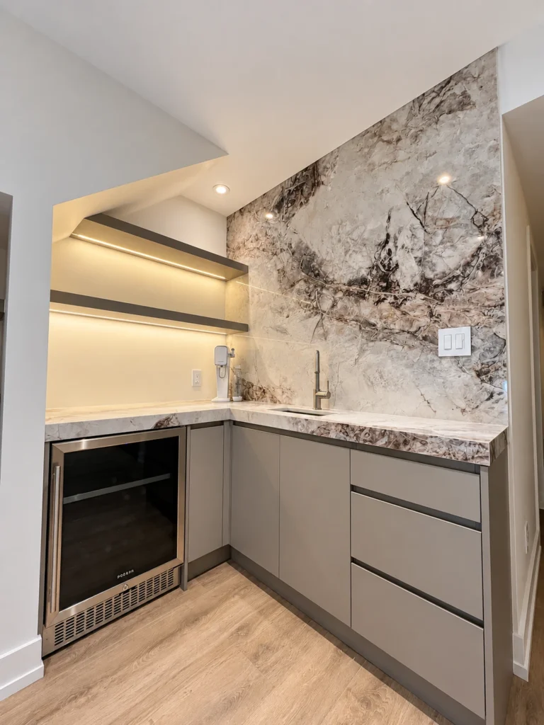Wet bar with illuminated floating shelves, marble backsplash, sink and beverage refrigerator